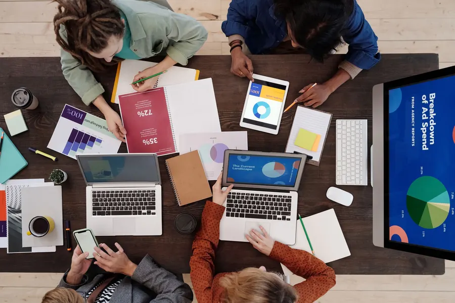 Meeting table with reports, laptops and notes