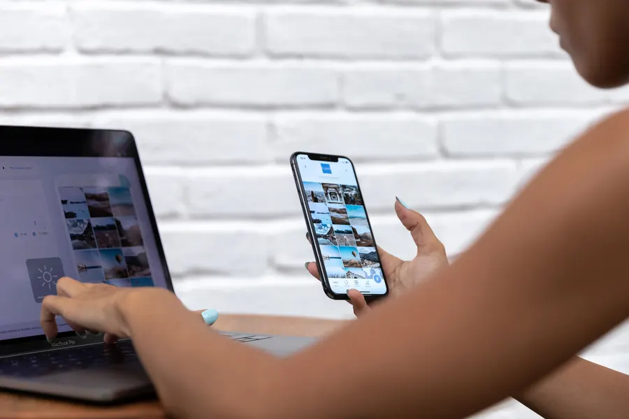 Person at a desk with a laptop and a phone